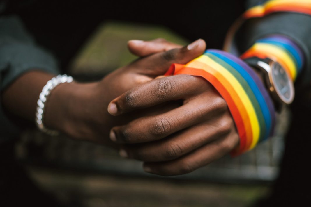 pexels-photo-5721294 crop unrecognizable black man wearing lgbt ribbon on arm