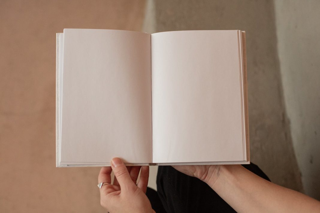 pexels-photo-6373293 woman holding book with blank pages