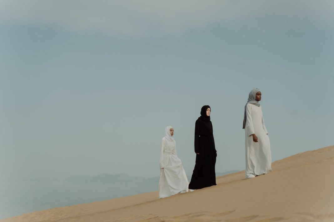 pexels-photo-9880859 women in hijab walking in the desert