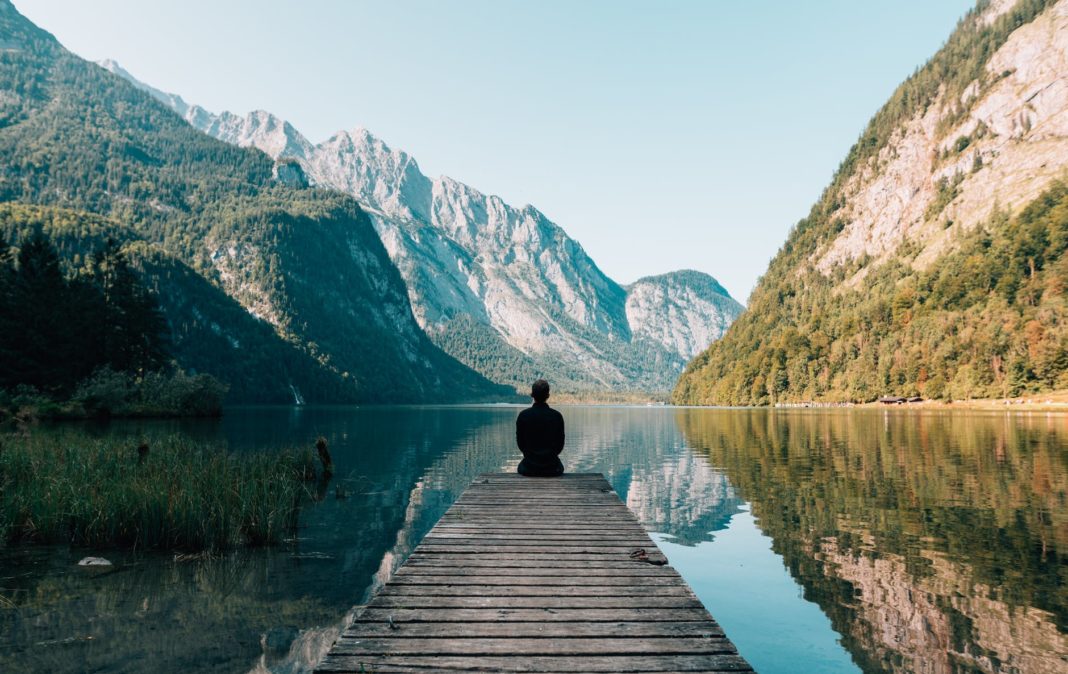 pexels-photo-747964 a person sitting on wooden planks across the lake scenery